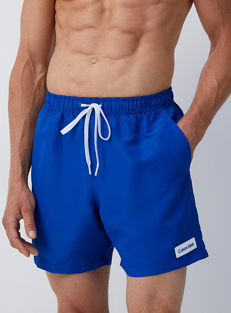 Calvin Klein: Le maillot short uni écusson logo Bleu pour homme