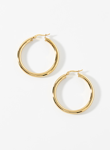 Large golden tubular hoops