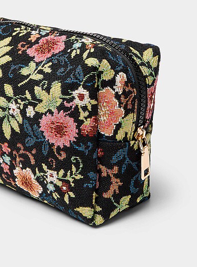 Floral tapestry cosmetics case with bottles