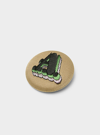 A embroidered badge pin