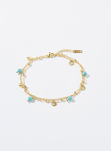 La cha&icirc;ne de cheville deux rangs turquoises et coquillages