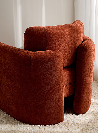 Rust brown curved backrest armchair