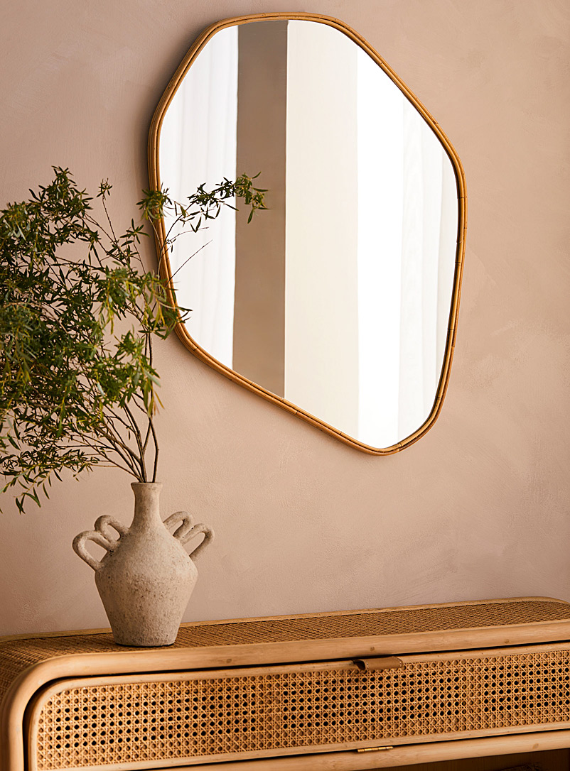 Rattan trim asymmetrical mirror product image (primary)