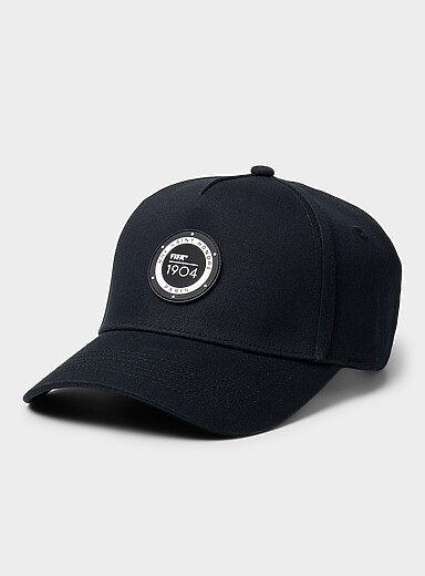 Circular emblem cap
