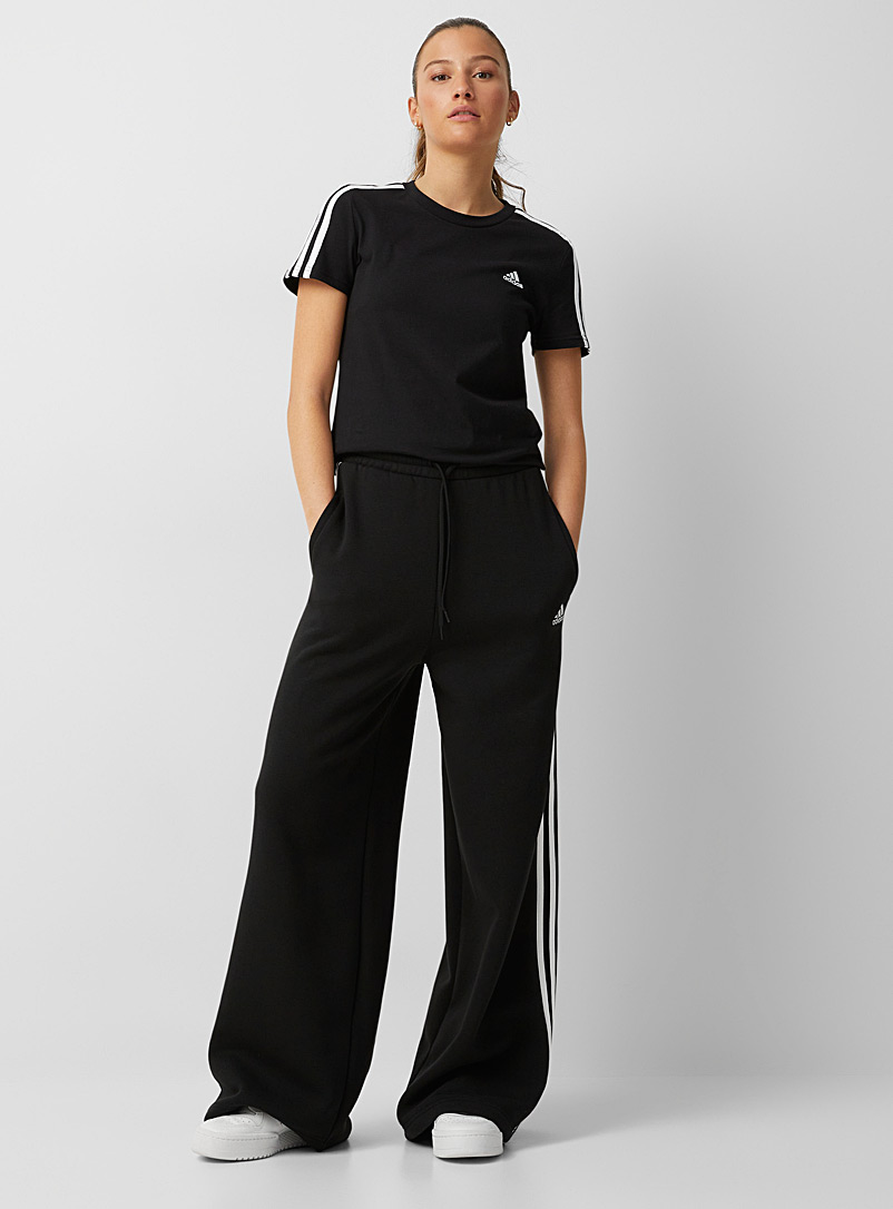 Adidas: Le pantalon large trois bandes Tiro Noir pour femme