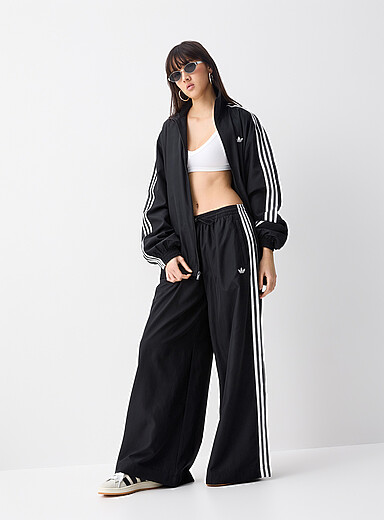 Adidas: Le pantalon <i>track</i> jambe large Firebird Noir pour femme