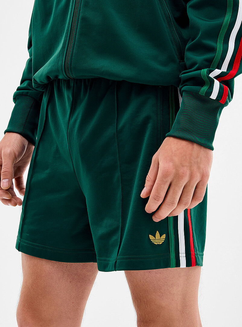 Adidas Originals: Le short <i>track</i> Firebird couleurs r&eacute;tro Vert pour homme