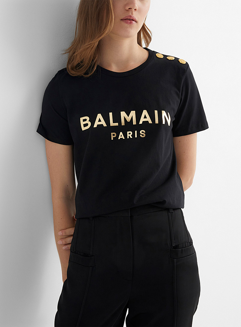 Balmain: Le t-shirt épaule boutonnée logo doré Noir à motifs pour femme