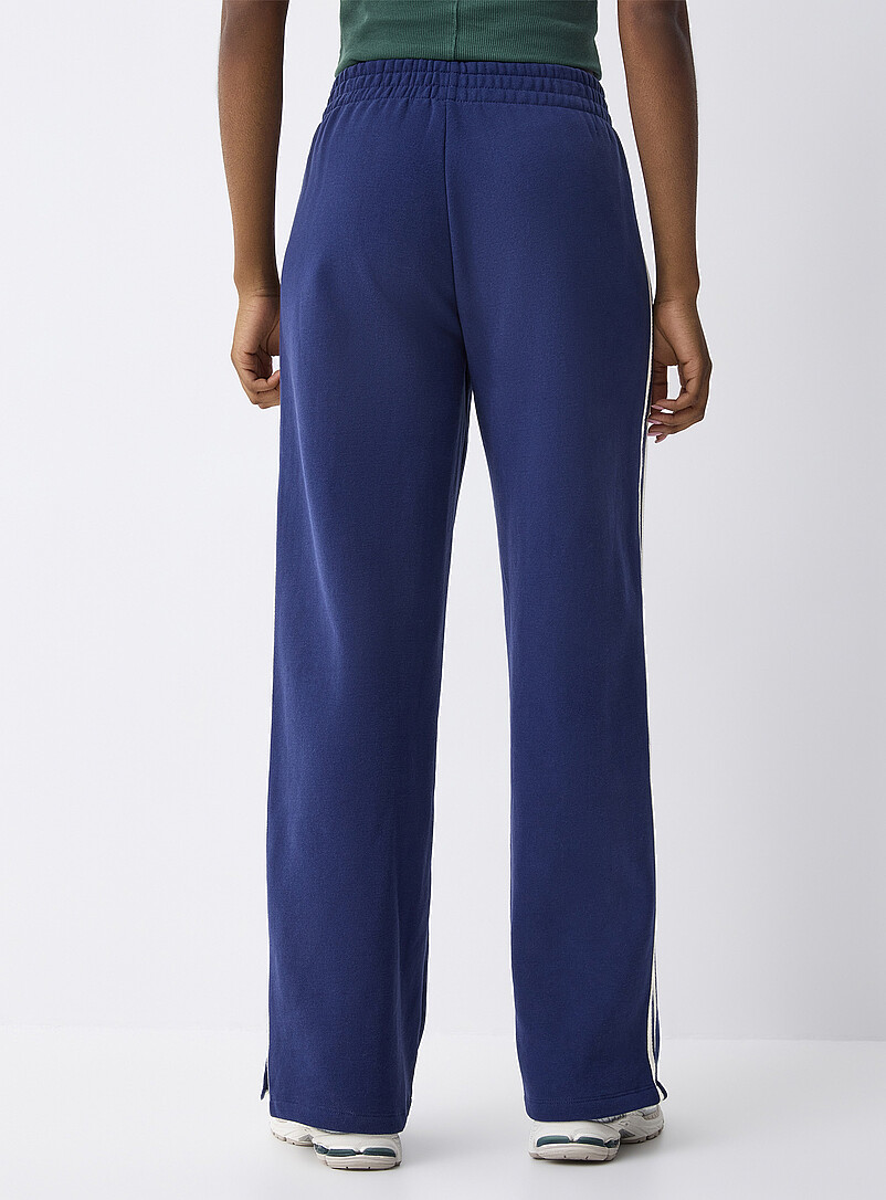 Twik: Le pantalon sweat large rayures <i>track</i> Rouge pour femme