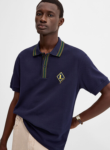 Lacoste: Le polo piqu&eacute; &eacute;cusson <i>preppy</i> Bleu marine pour homme