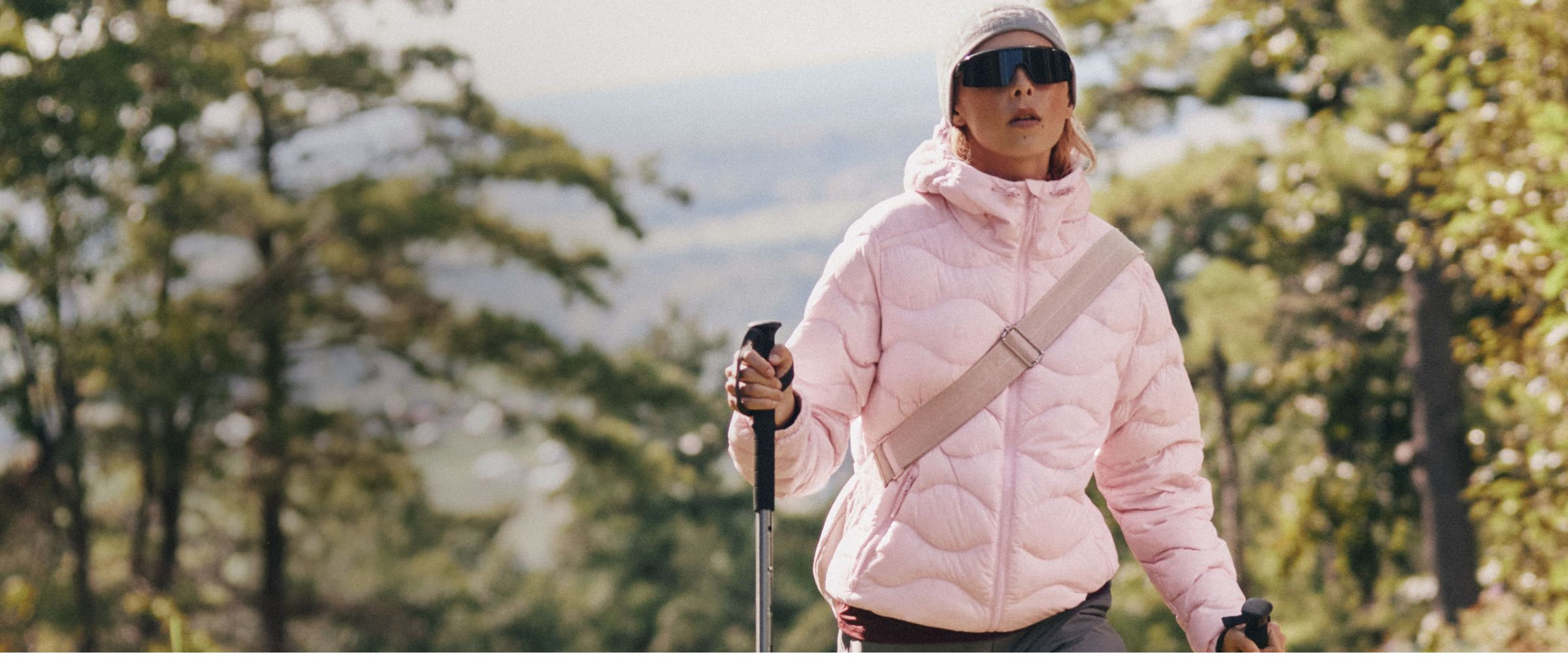 Woman wearing a sporty blush pink hooded quilted jacket