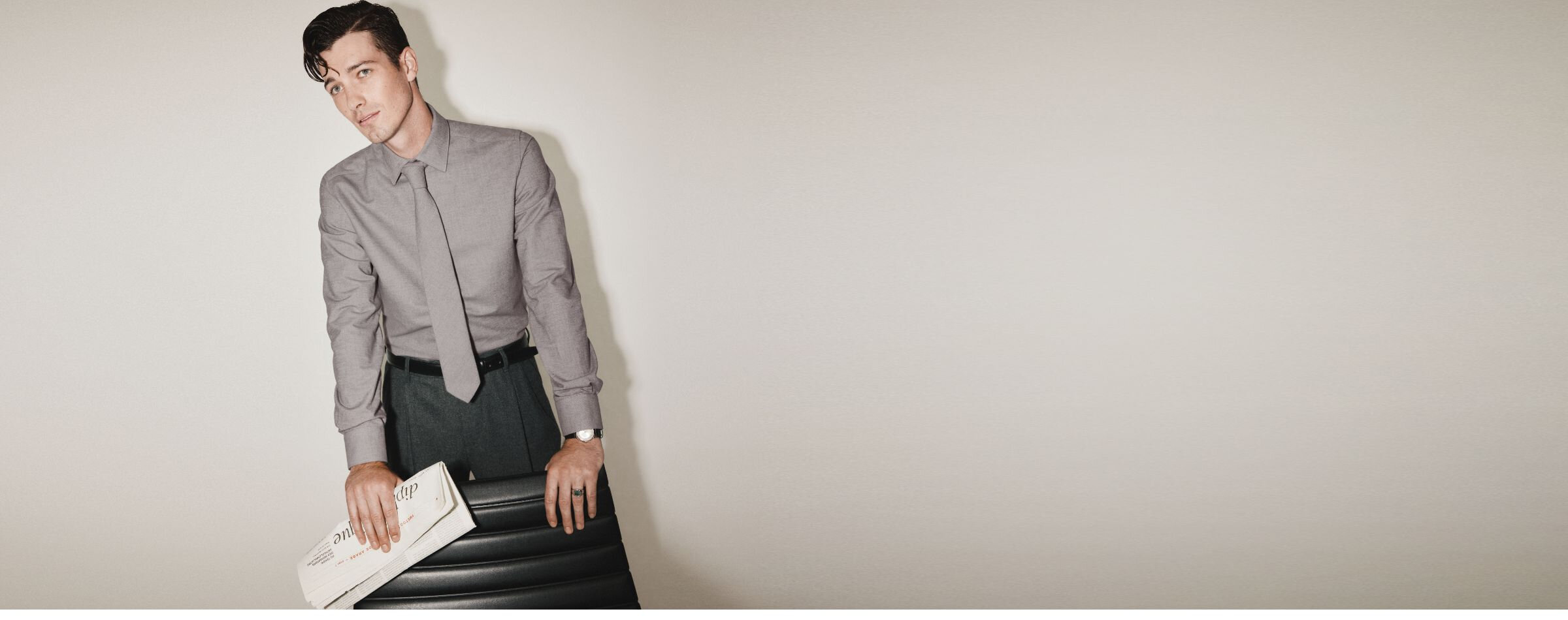 Un homme porte une chemise et une cravate grises