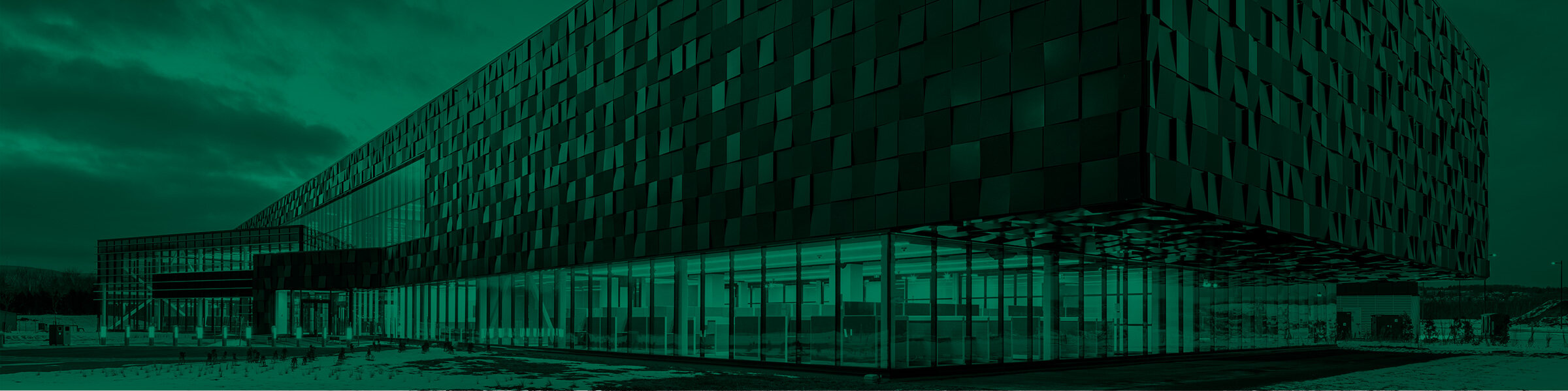 Green background with a photo of the Simons Campus