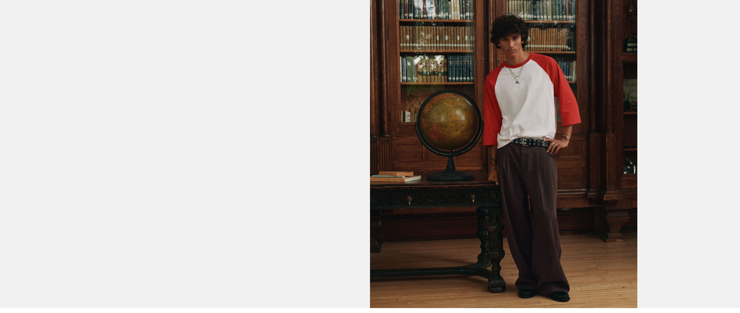 A young man wearing dark brown double-pleat baggy chinos