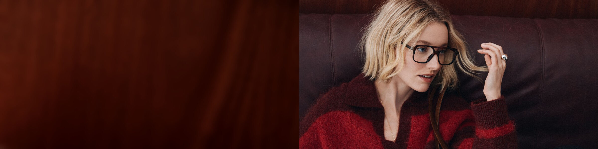 A woman is wearing a red striped sweater
