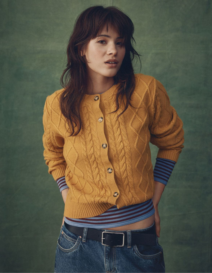 Young woman wearing a mustard yellow cardigan