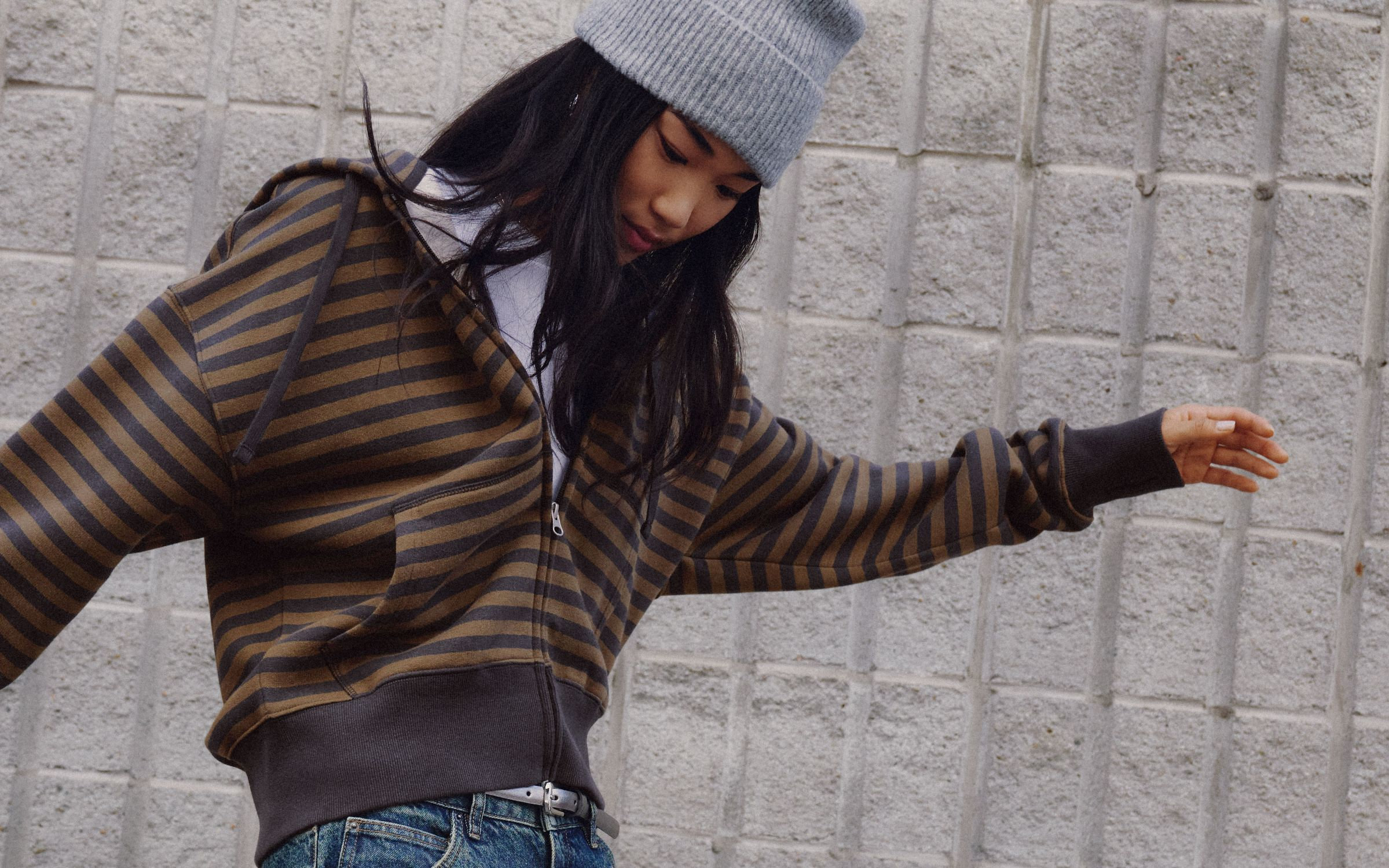 Young woman wearing a striped zipped hoodie