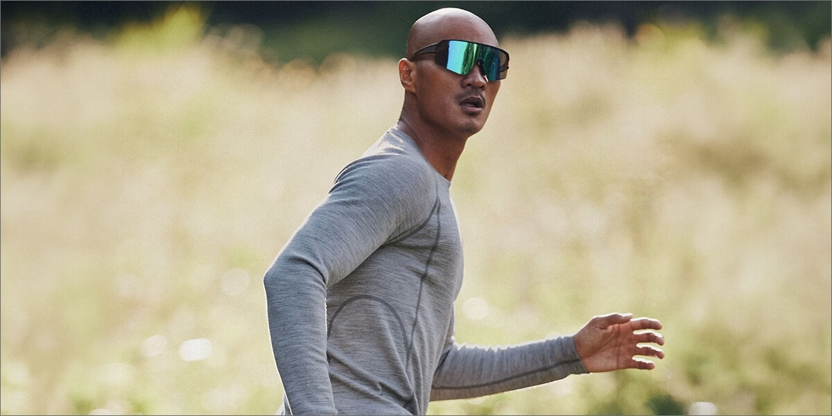Man running on the street wearing a green long-sleeve T-shirt