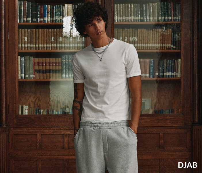 Young man wearing a white T-shirt with gray sweatpants