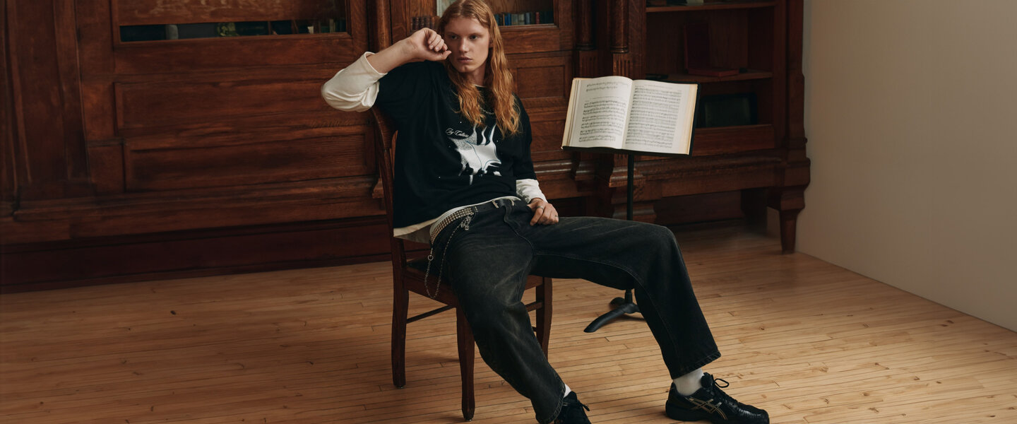 A young man wearing a pair of washed black Djab exclusive jeans