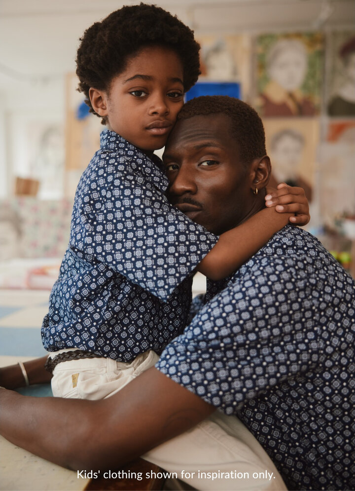 A father and son are wearing blue shirts.