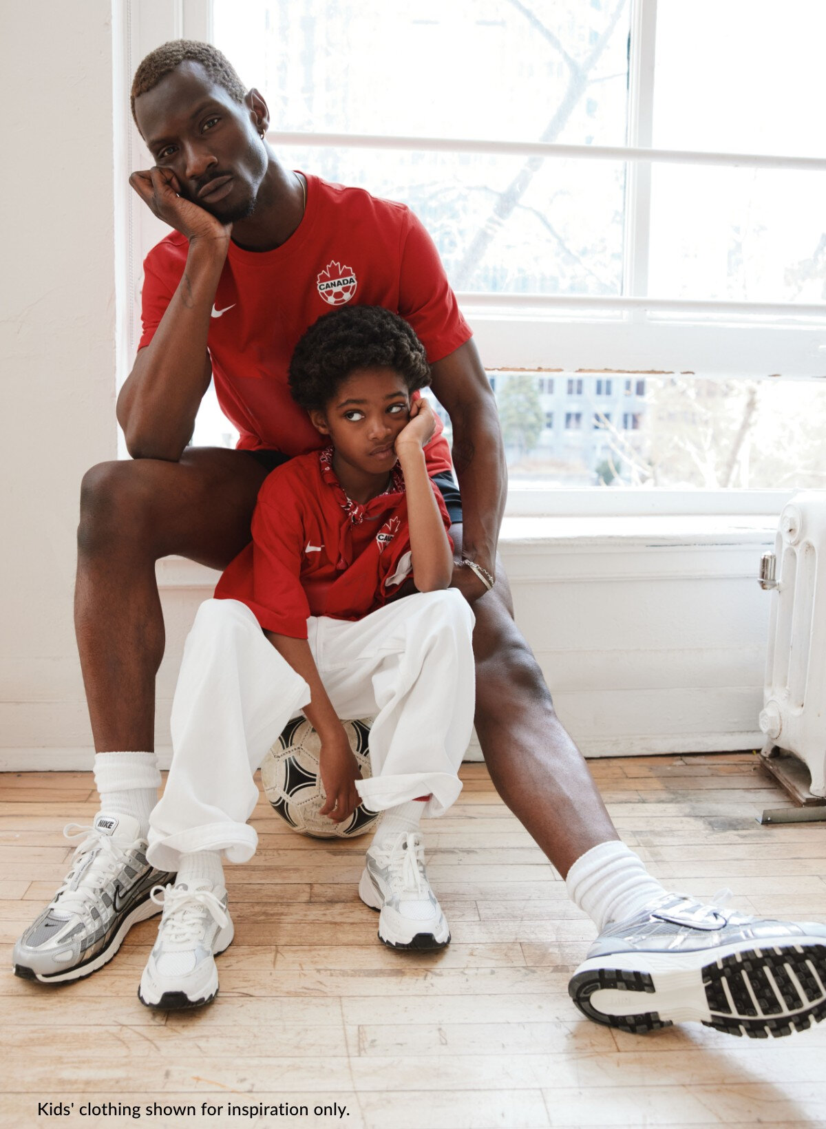 A father and son are wearing Team Canada t-shirts.
