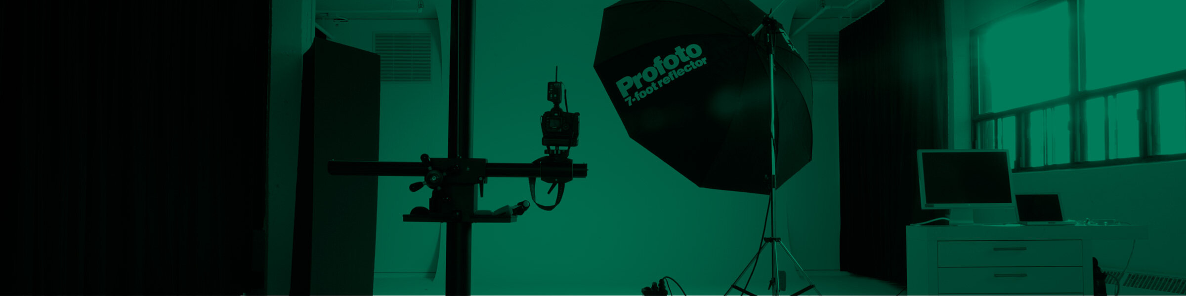 Green background with a photo of the Simons studio