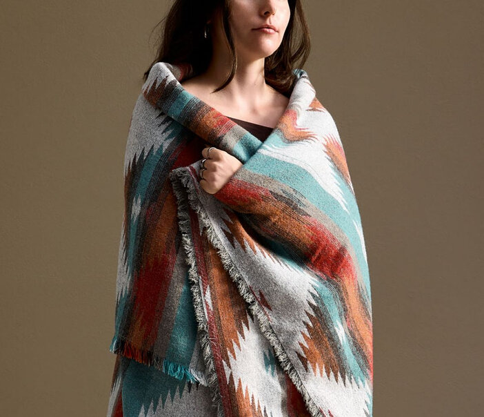 a woman and a patterned blanket